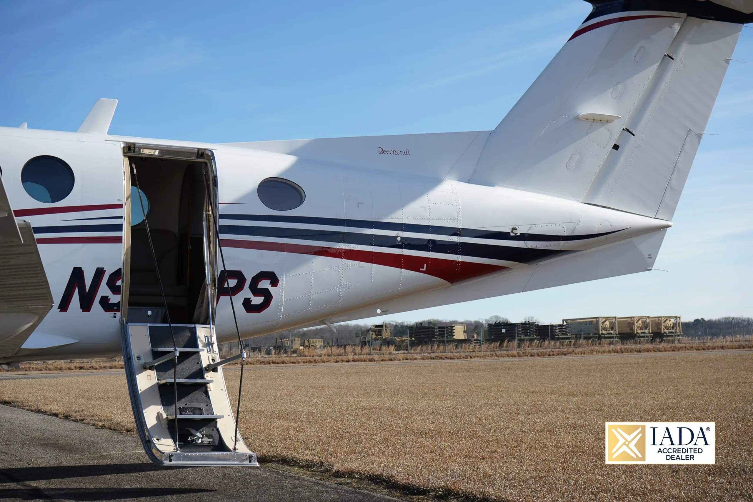 The tail section of a Beechcraft King Air 250 with the door open.
