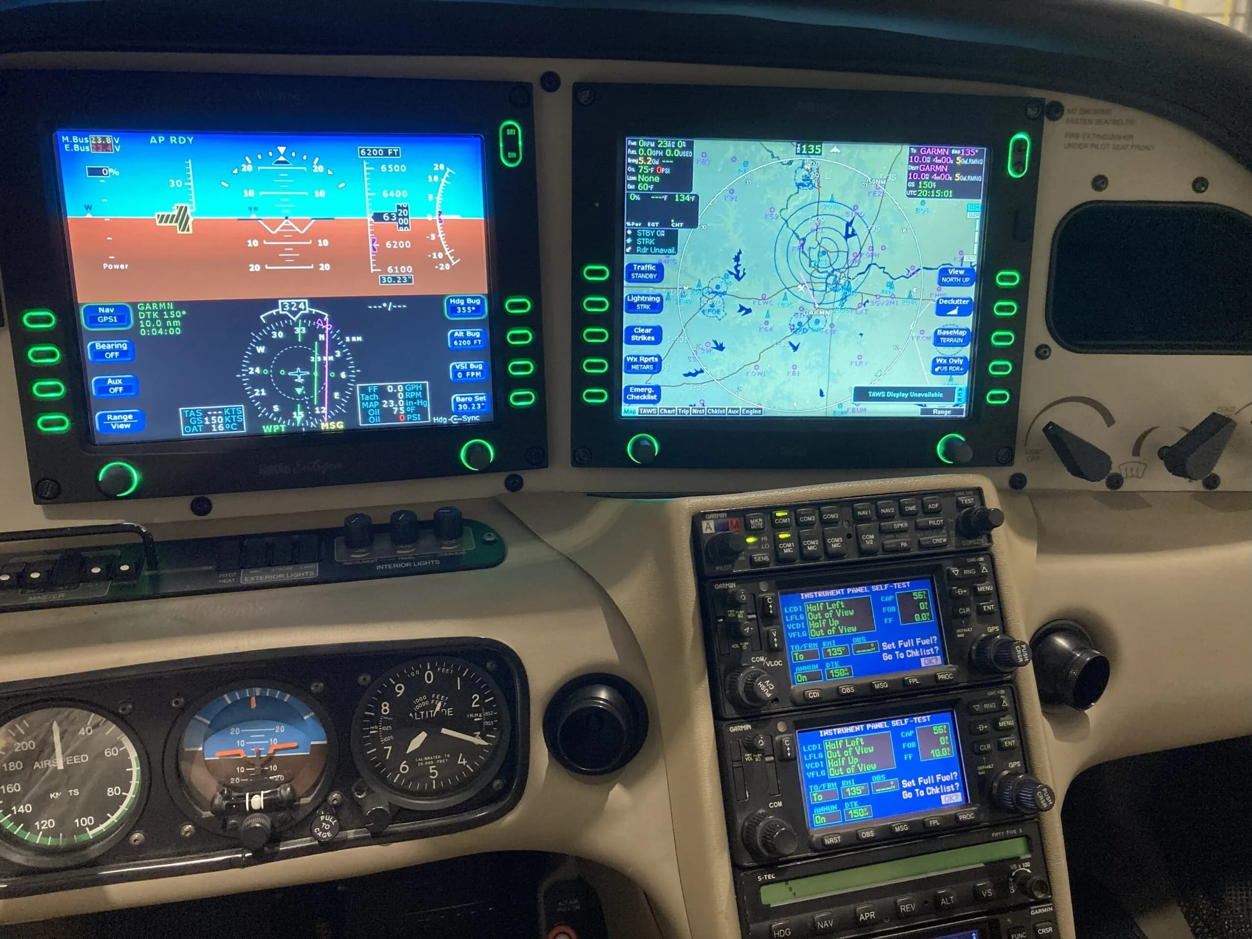The instrument panel of a Cirrus SR22 aircraft, featuring two large display screens and radio stack.