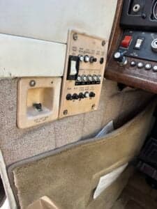 A close-up of the interior side panel of the Cessna 182 Skylane, showing switches and controls.