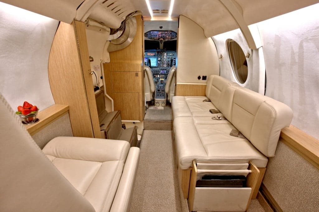 View down the aisle of the Hawker 4000 cabin, showing the seating arrangement and interior finishes.