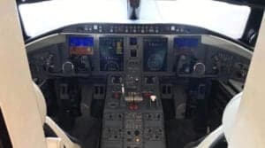The aircraft cockpit is shown with the instrument panel and seats.