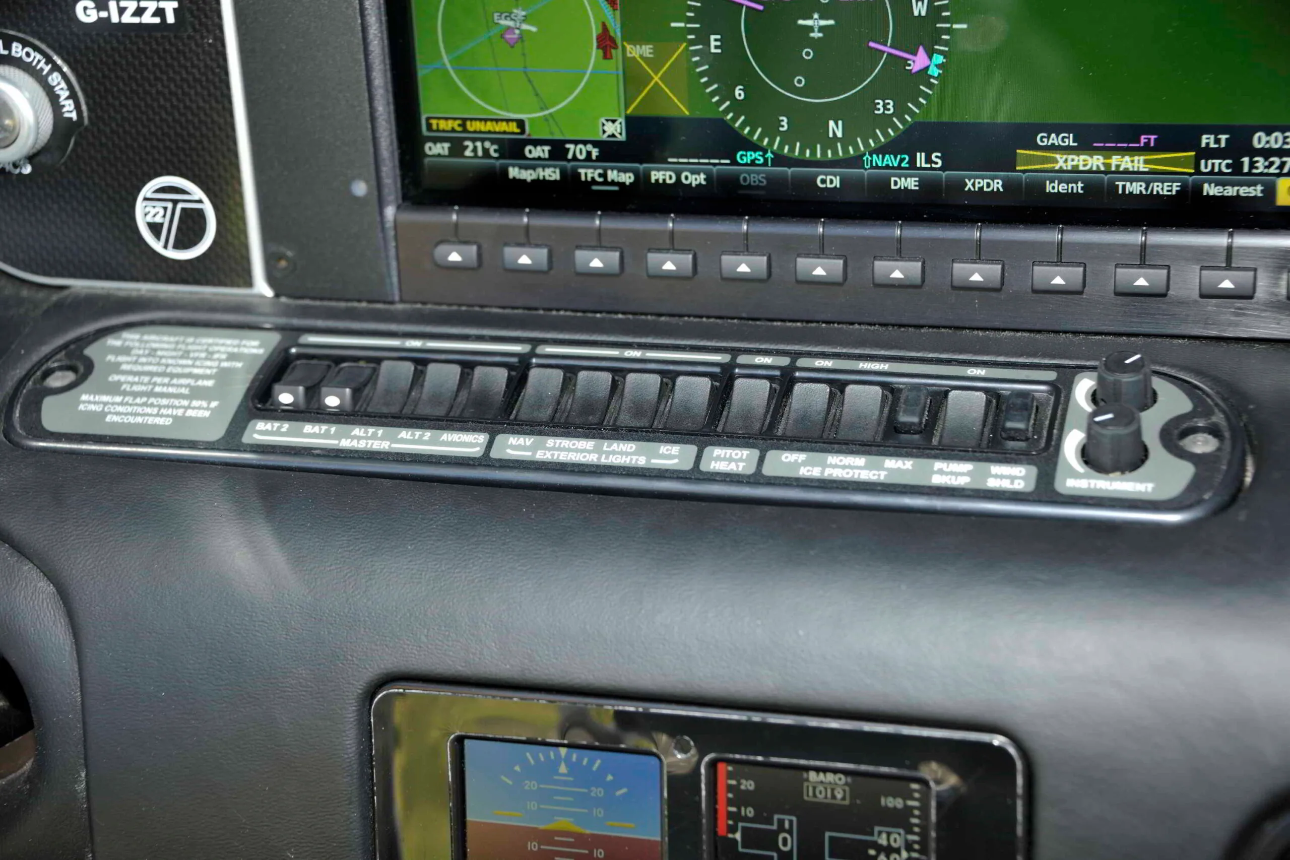 A close-up of the aircraft's switch panel in the cockpit, showing various controls for lights and systems.