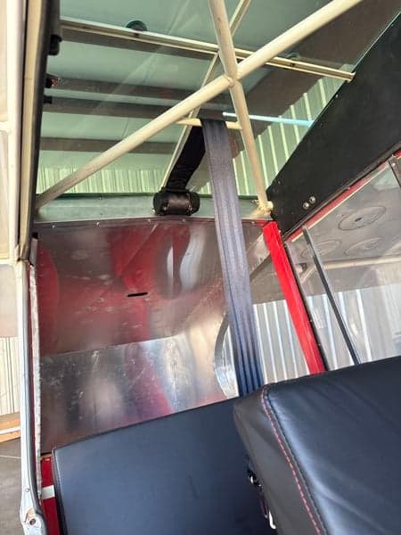 View of the aircraft's interior showing the seat and seatbelt.