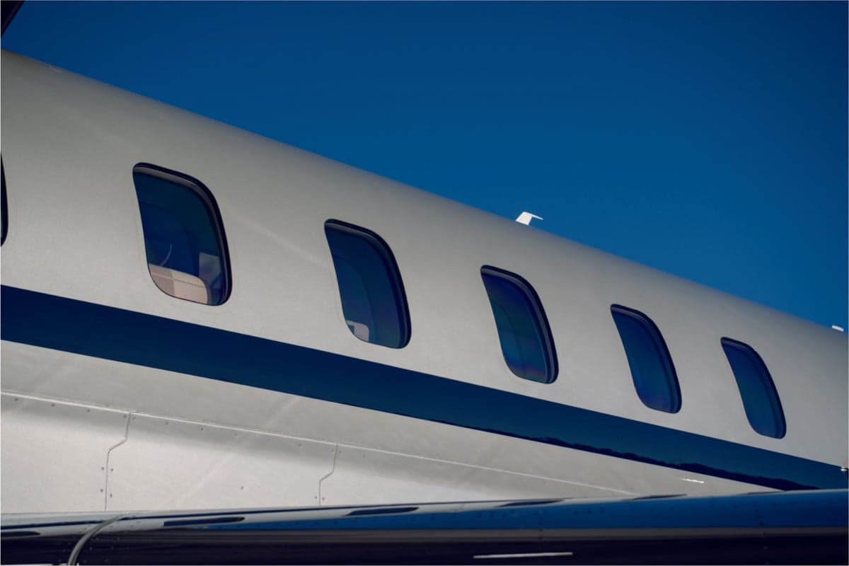 Close up of the fuselage windows of N988DX.