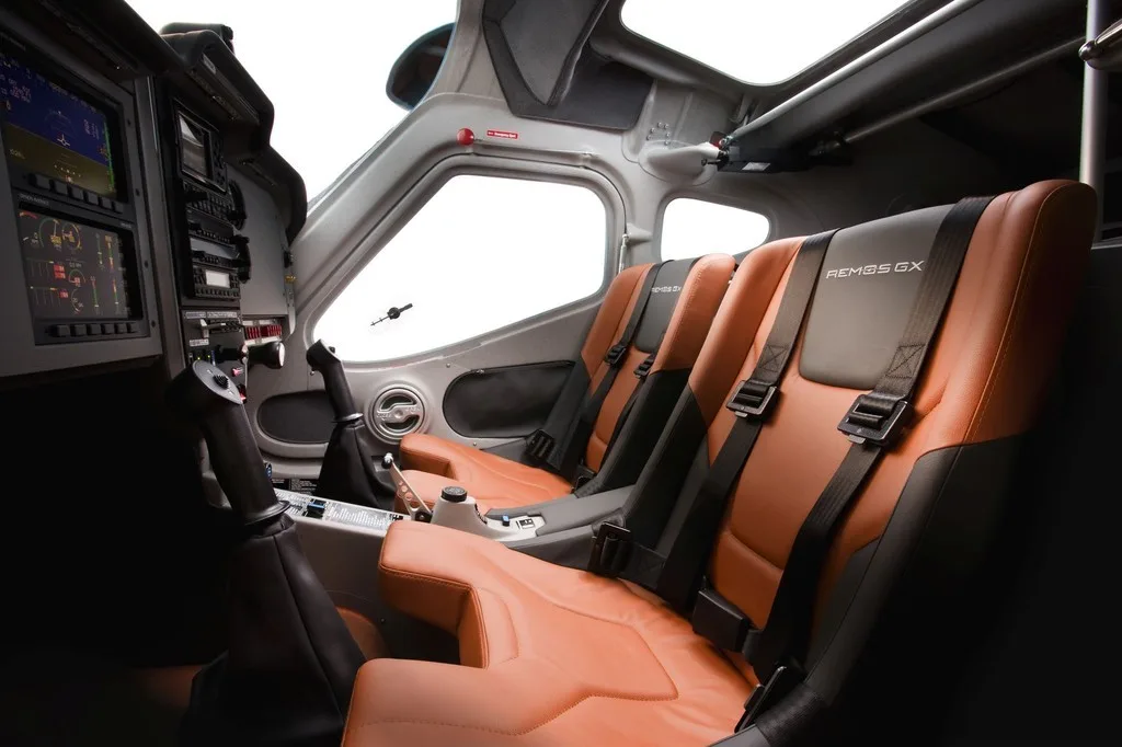 Interior view of the REMOS GX cockpit with brown seats.