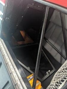 View inside the aircraft's cargo area, showing the frame and interior panels.