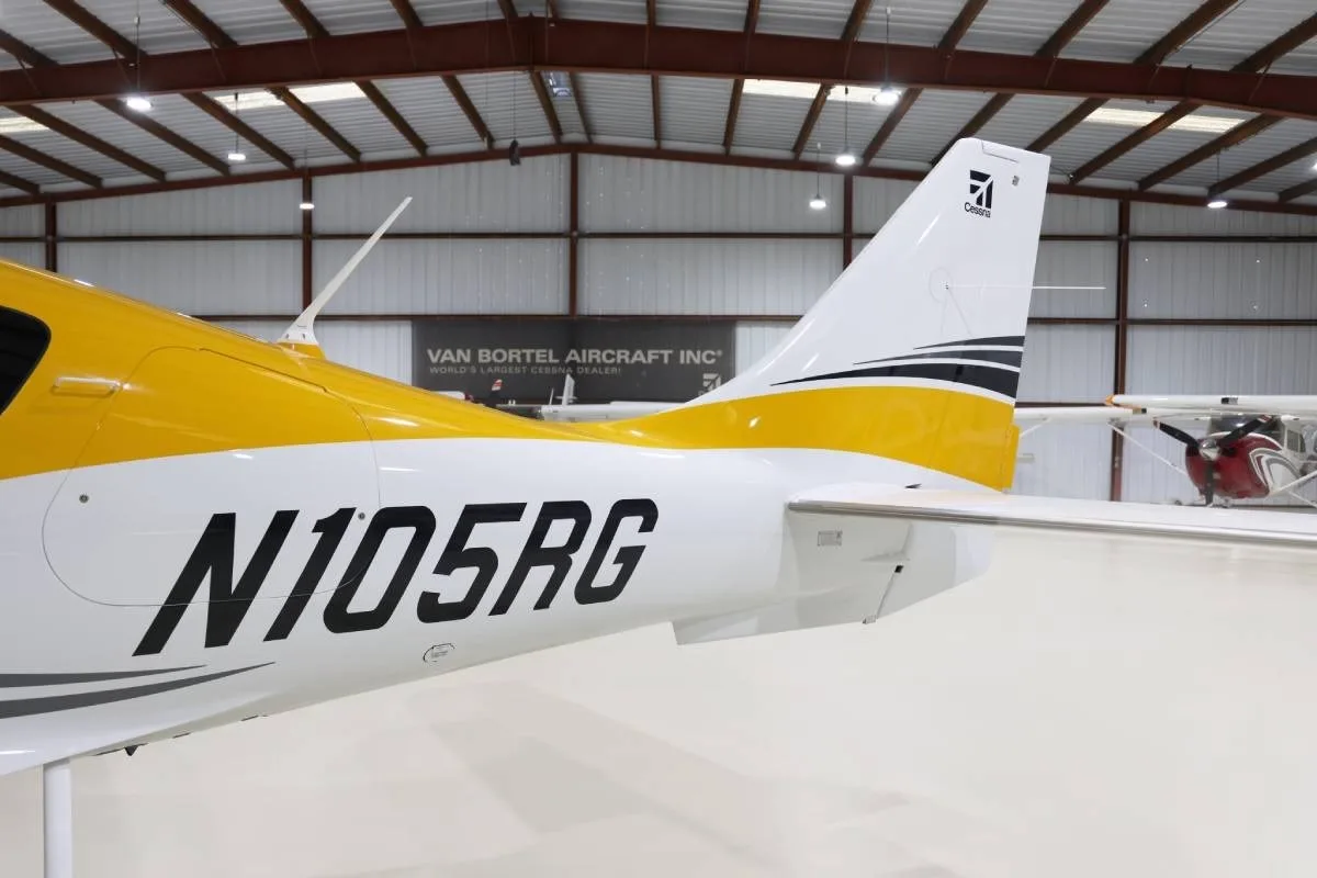 A close-up of the tail section of the yellow and white Cessna TTx, showing the N105RG registration.