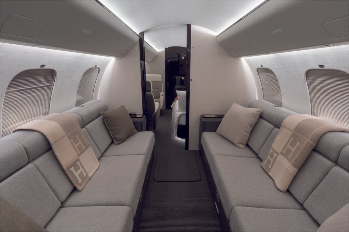 Bombardier aircraft interior with two couches facing each other.