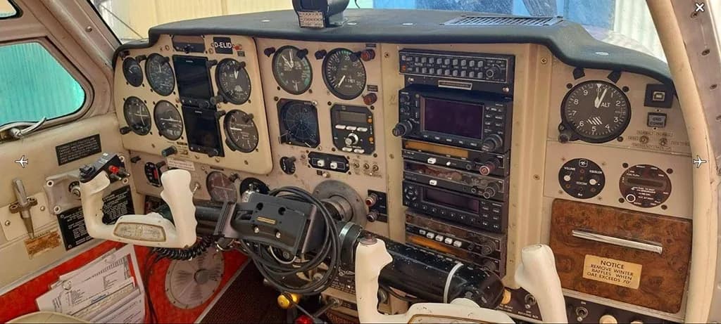 A detailed view of the aircraft's cockpit instrument panel, showing gauges, radios, and controls.