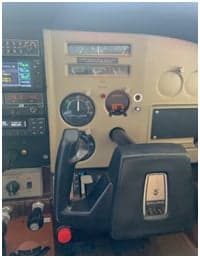 Close-up of the instrument panel and controls in the cockpit of a Cessna 182 Skylane.