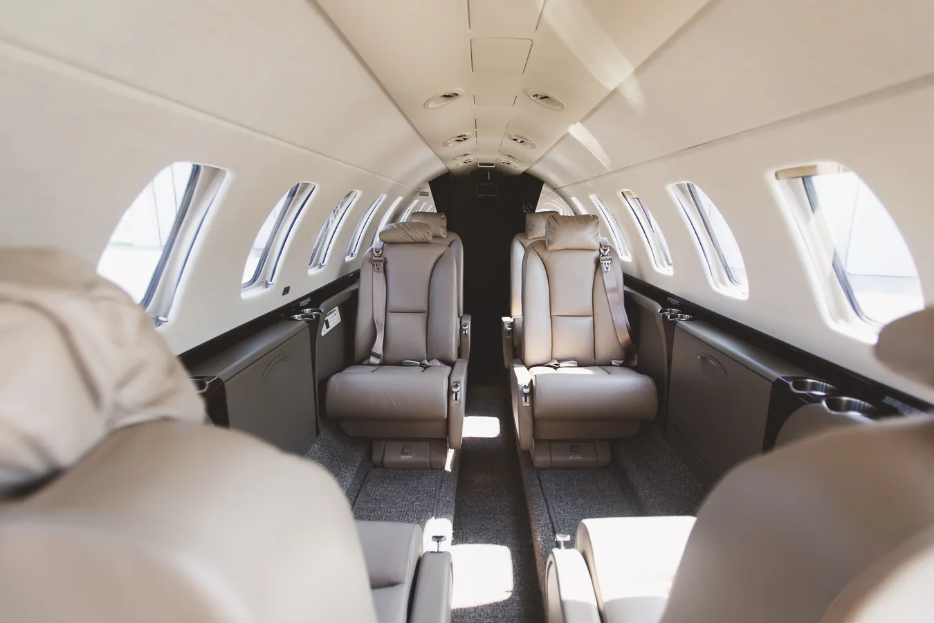 View of the aircraft cabin with tan leather seats.