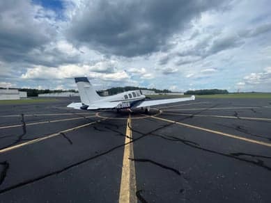 Side view of the tail of a Beechcraft Bonanza with the registration number N838EB.