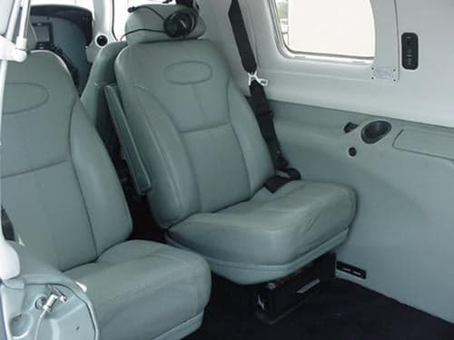 The interior of the aircraft with light gray leather seats.