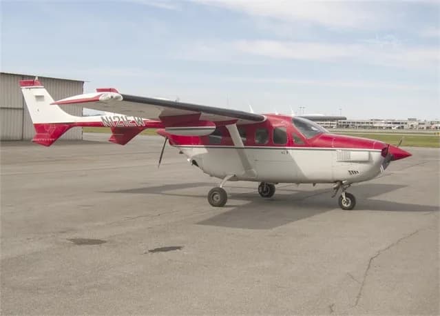Side view of the Cessna Skymaster N121EW on the tarmac.