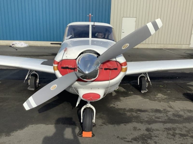 Front view of the C-FLXA aircraft with a red and white paint scheme.