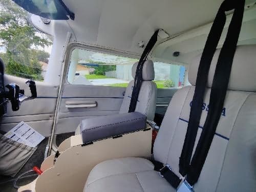 The interior of the Cessna 172 Skyhawk, showing the seats and side panel.