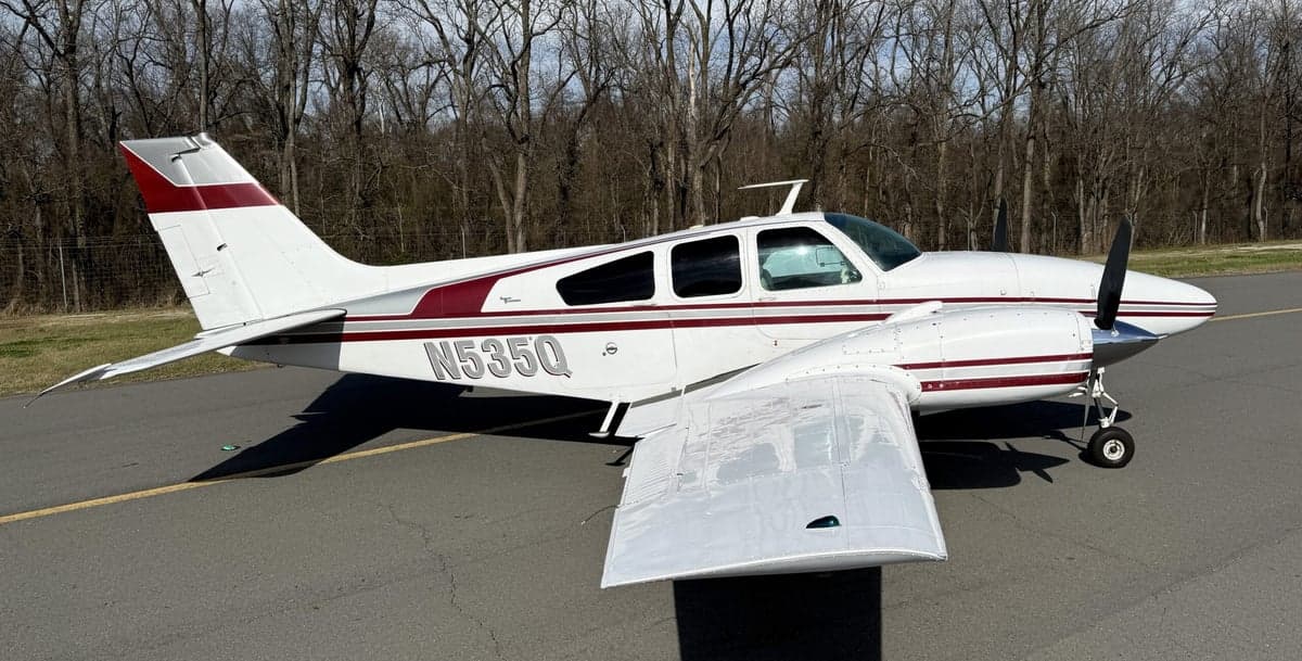 N535Q Beechcraft on the tarmac with a white and maroon paint scheme.