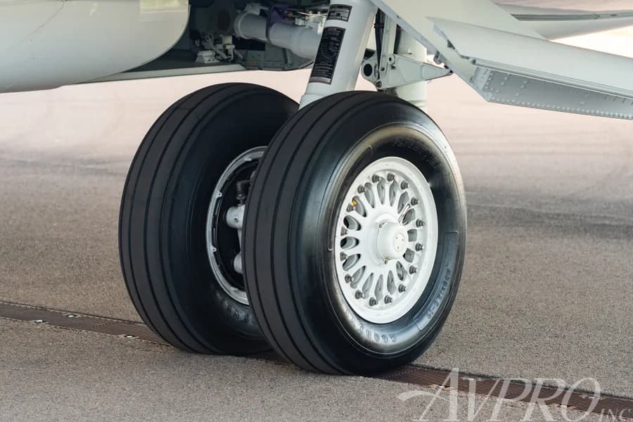 A close-up view of the main landing gear wheels of a business jet.