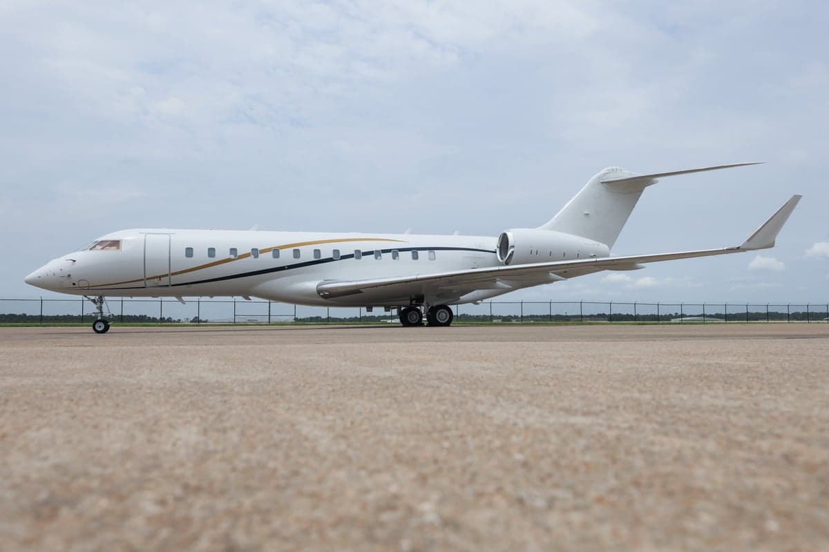 Side view of a white Bombardier Global Express aircraft on the tarmac.