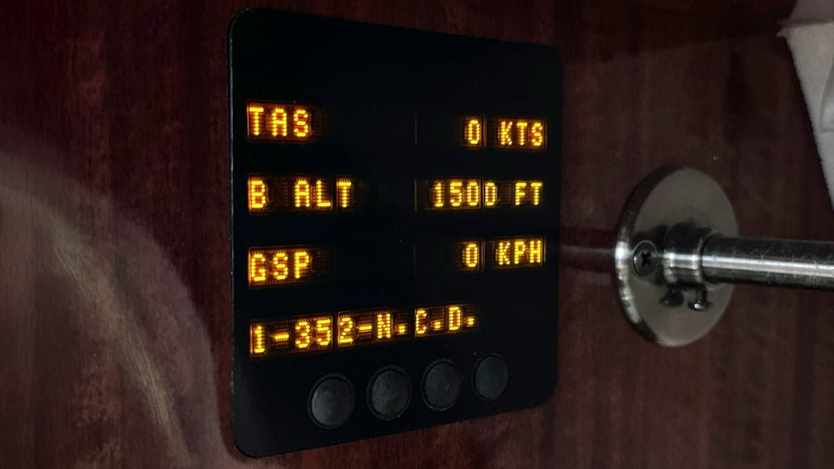 Close up of a cockpit display screen showing flight information.