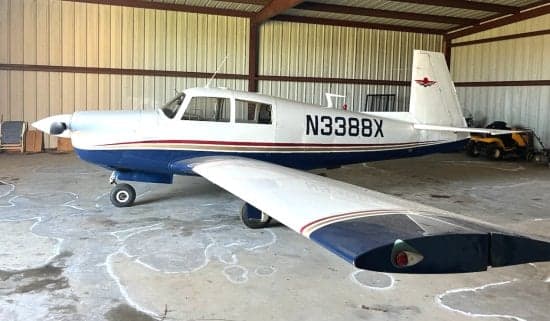 Side view of the N3388X aircraft inside a hangar.