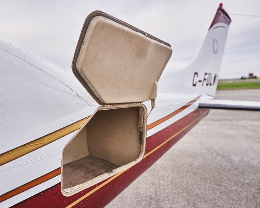 Open baggage compartment door on the side of an aircraft.