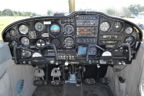 The cockpit features a black instrument panel with various gauges and controls.