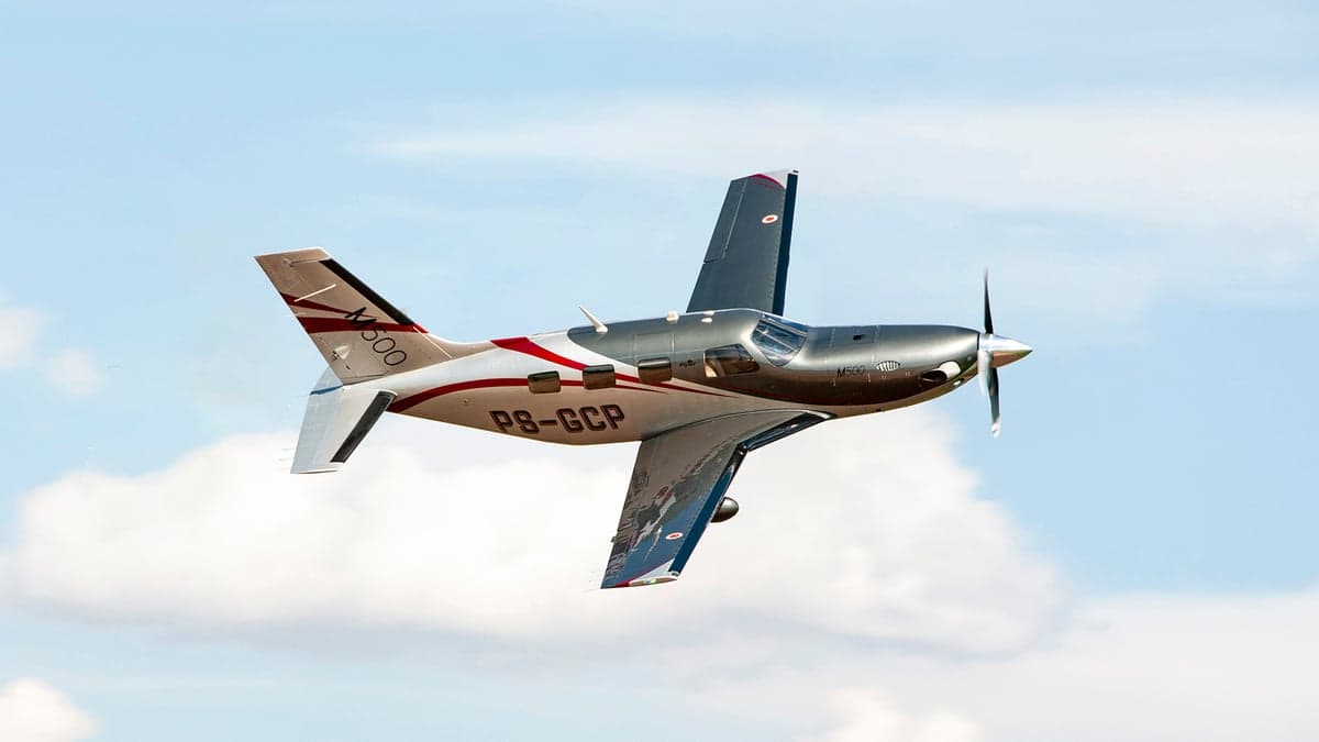Piper M600 in flight against a cloudy sky.
