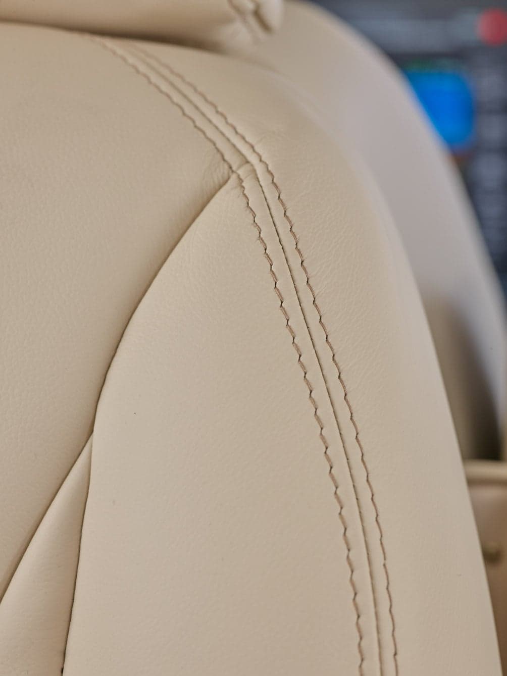 Close up of the stitching on a leather aircraft seat.