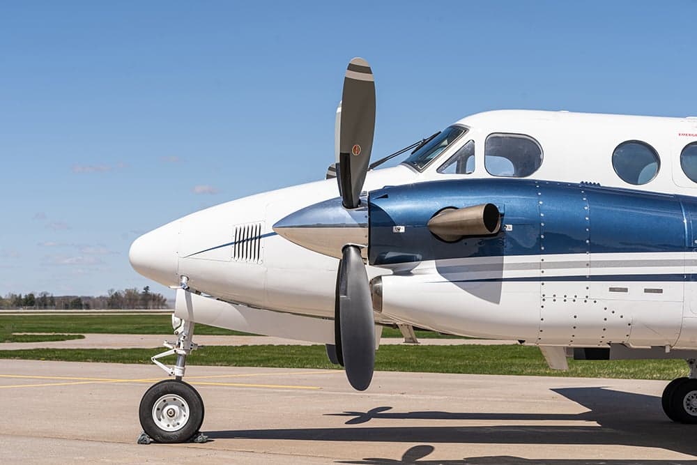 Close-up of the nose and propeller of a Beechcraft King Air 350i aircraft.