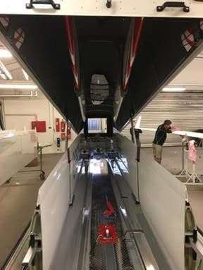 HB-2560 glider being worked on in a hangar.