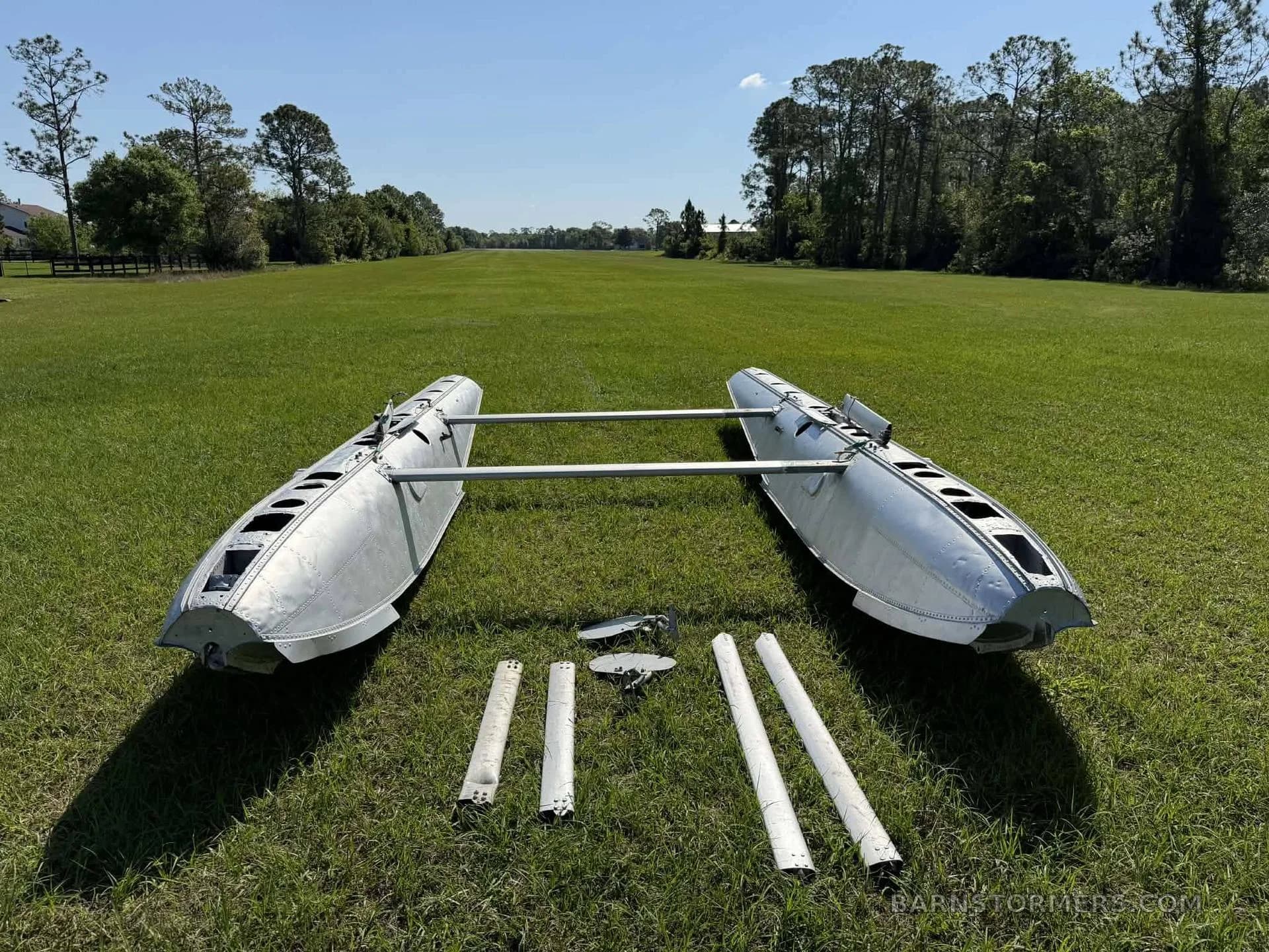 EDO float barrels with additional parts displayed on grass.
