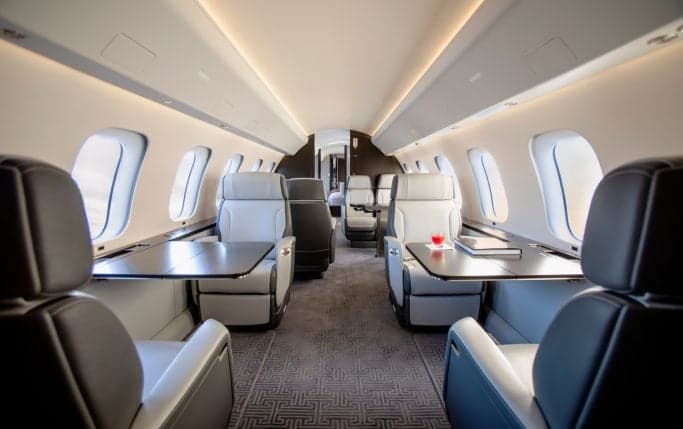 Interior view of the Global 7500 cabin with leather seats and a welcome screen.