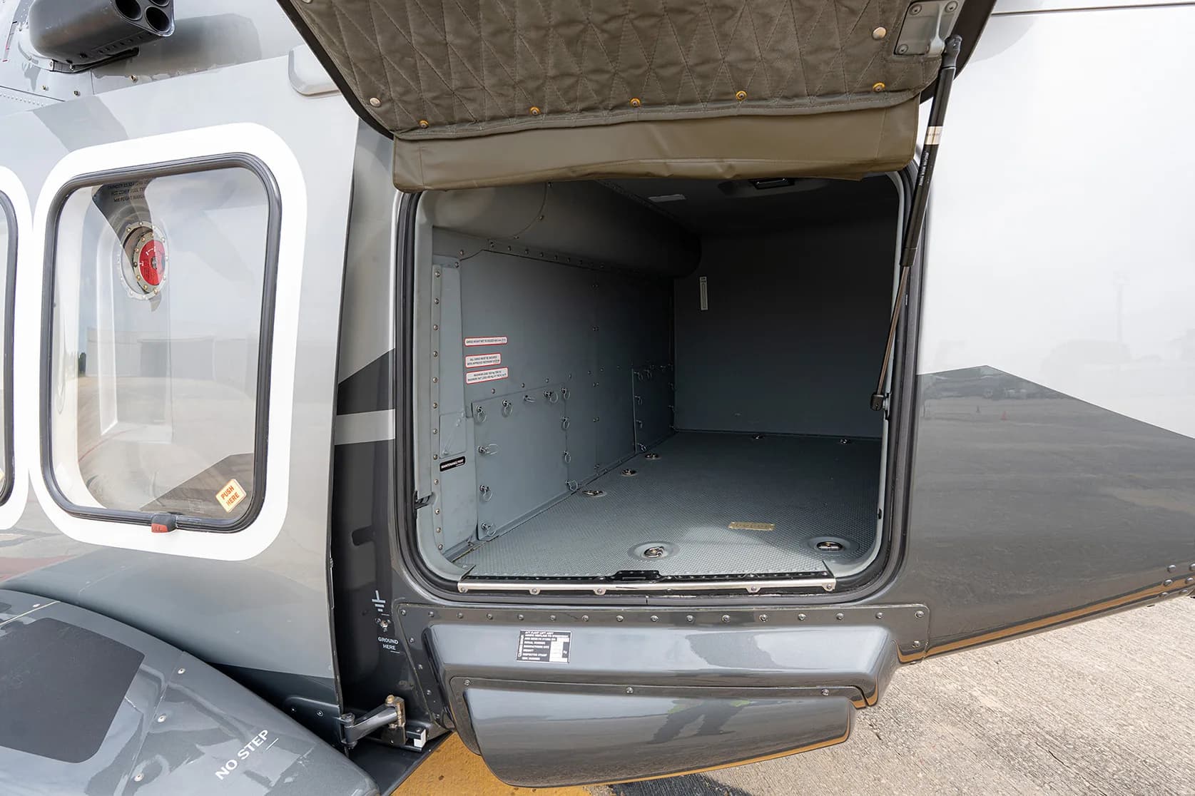 Open cargo door of the helicopter revealing the empty cargo area.