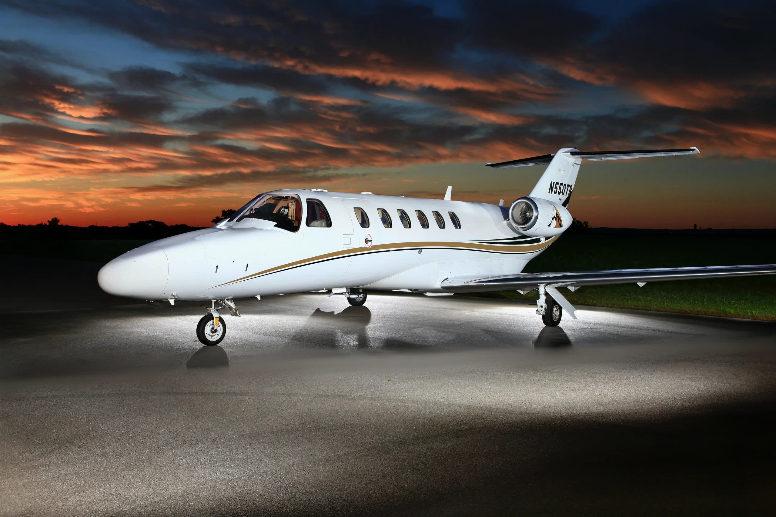 A Cessna Citation CJ1+ aircraft with registration N550TB parked on the tarmac at sunset.