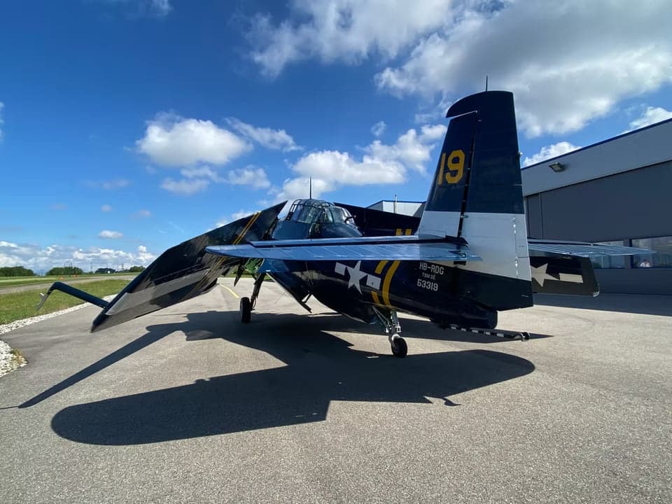 Grumman TBF Avenger parked on the tarmac with folded wing.