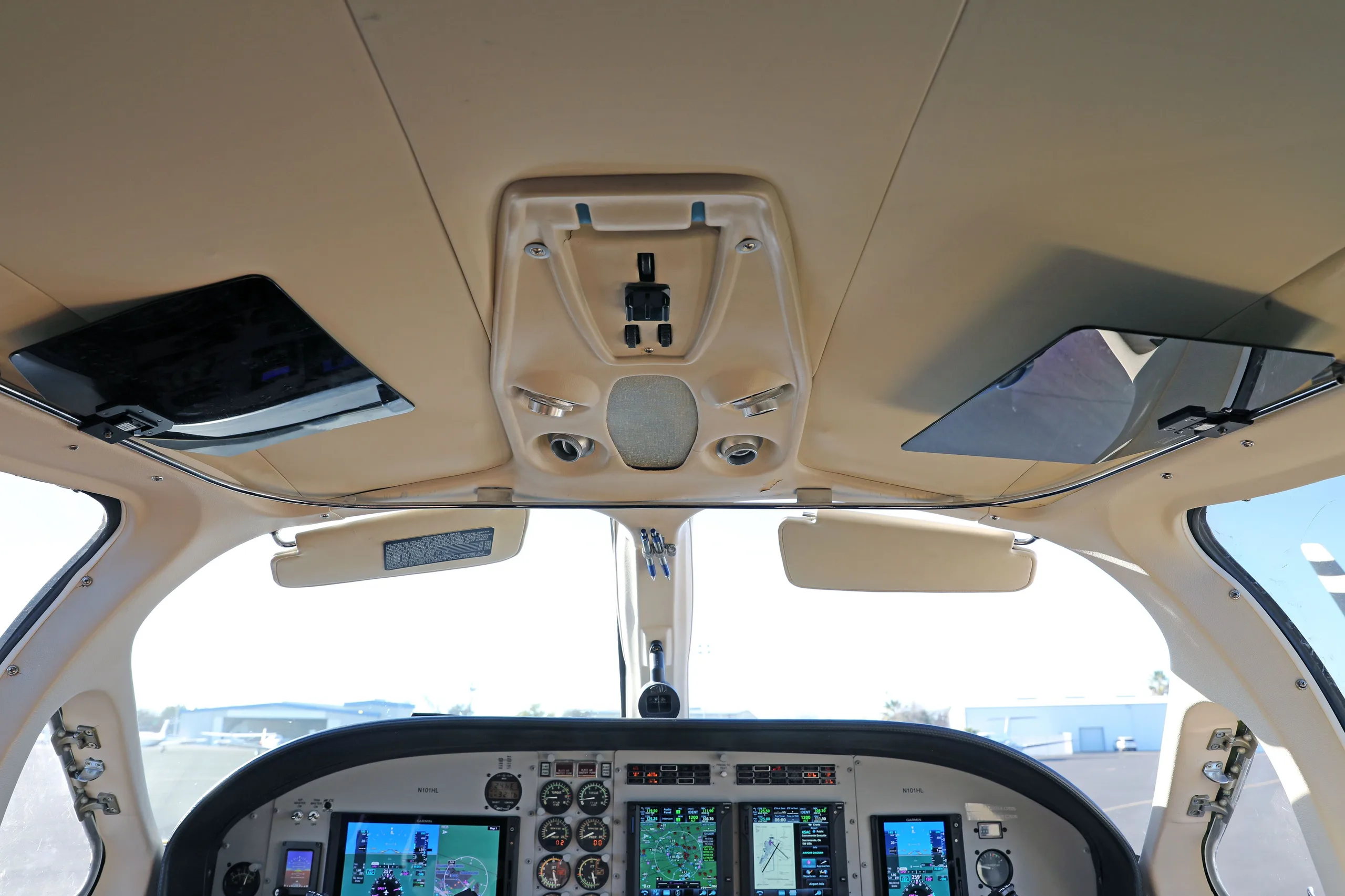 An overhead view of the Cessna 414 Chancellor cockpit, showing the ceiling panel and windshield.