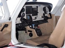 View of the cockpit instrument panel and pilot seat.