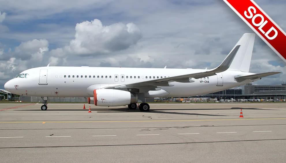 A white Airbus A320 family aircraft, registration VP-CHA, parked on an airport tarmac under a cloudy sky.