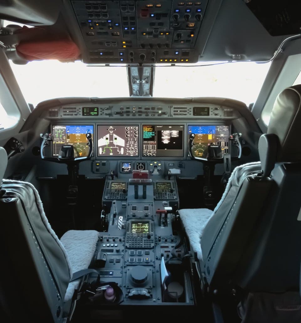 View of the cockpit instrument panel and seats.