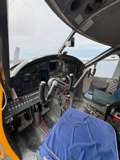 View of the aircraft cockpit with the water visible through the windshield.