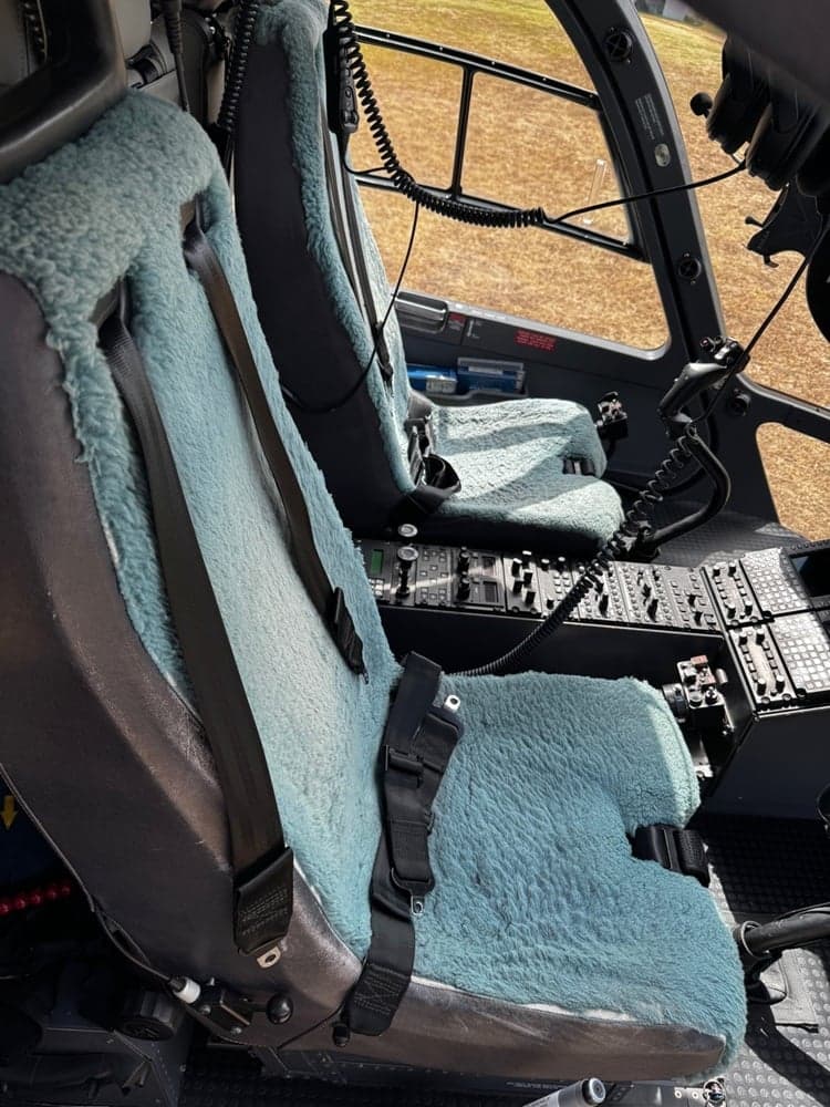 Helicopter cockpit seats with sheepskin covers.