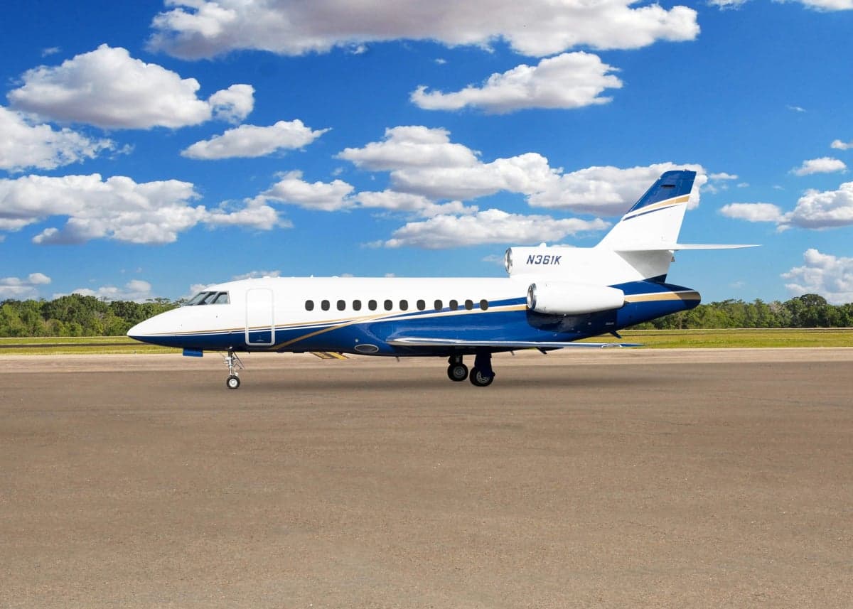 A Falcon aircraft with tail number N361K is parked on the tarmac.