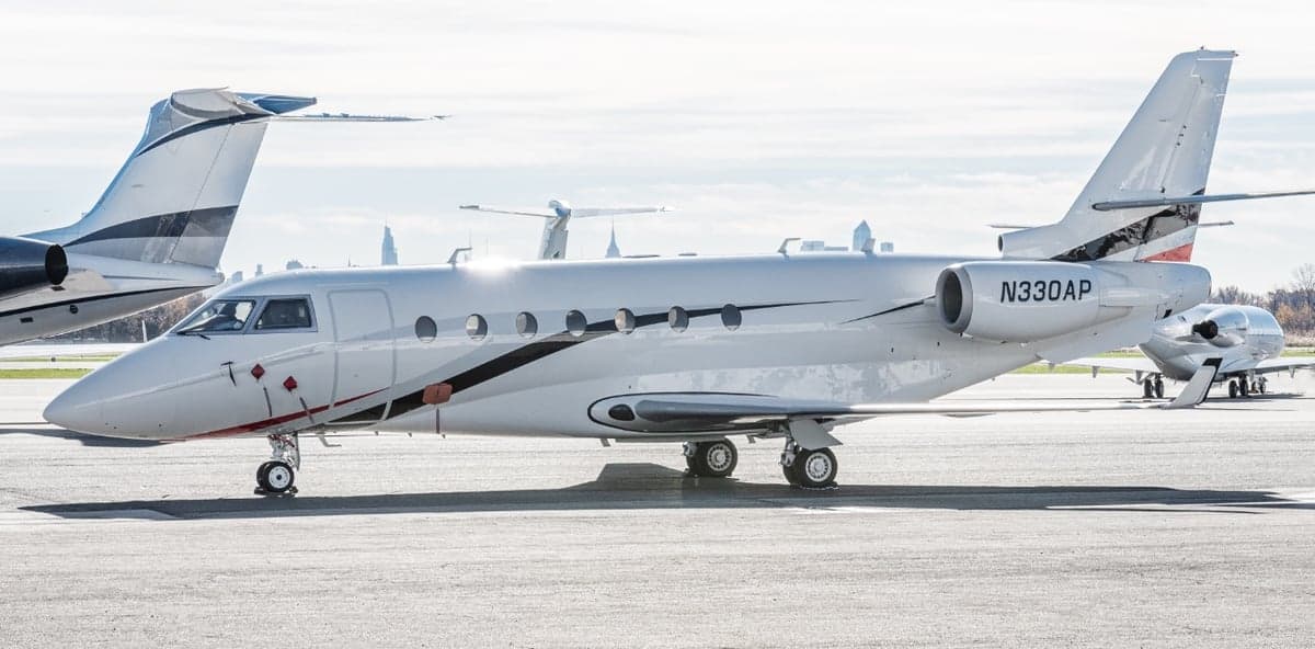 Side view of the N330AP aircraft on the tarmac.