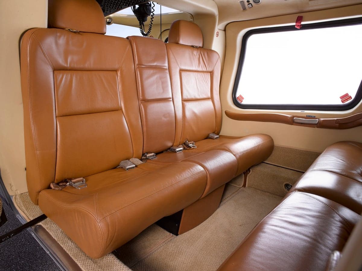 Rear cabin seats upholstered in brown leather.