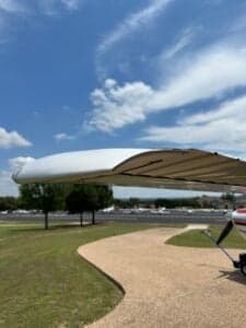 Partial view of a Cessna 182 Skylane wing and fuselage, registration N71699, parked on a paved surface.