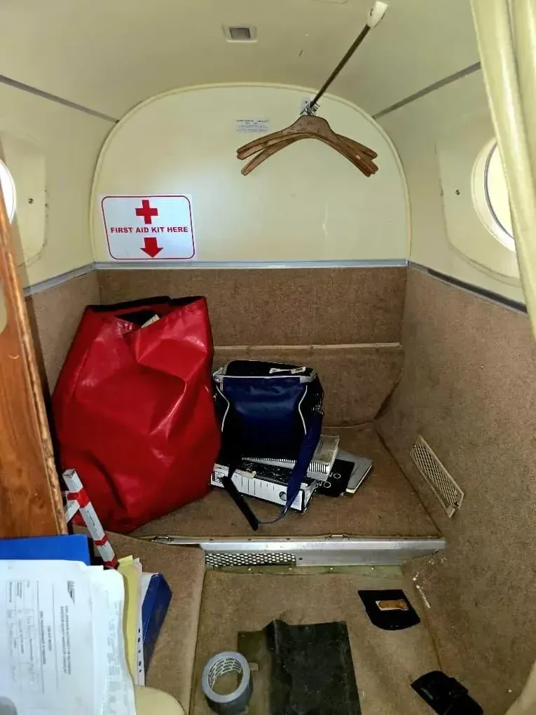 View of the aircraft's storage area with a first aid kit.