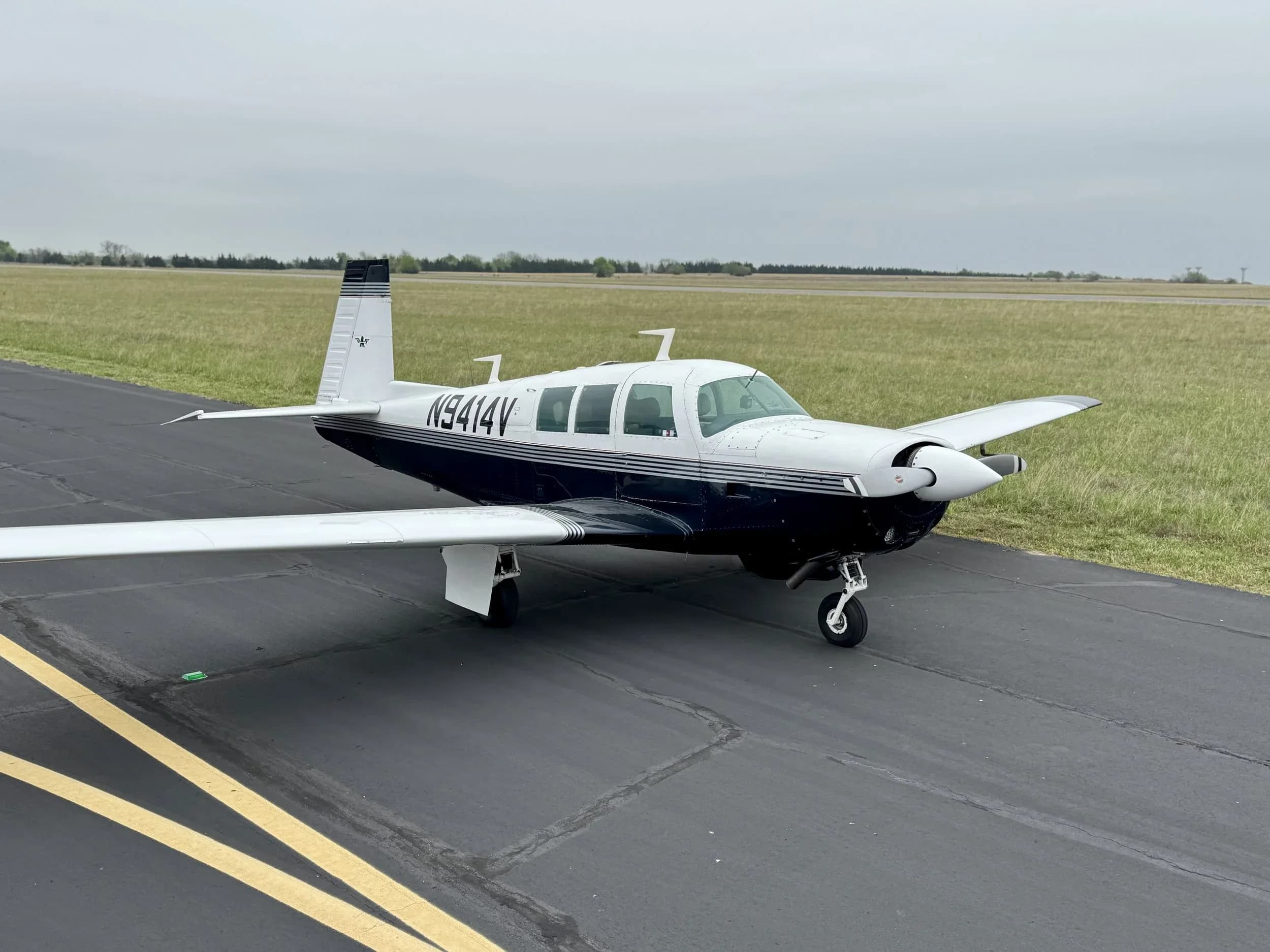 A Beechcraft Bonanza aircraft with registration N9414V is parked on the tarmac.