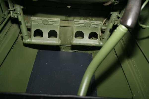 View of the cockpit showing the rudder pedals and control stick.