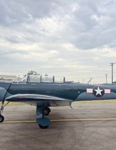 Side view of the gray N700YK aircraft on the tarmac.